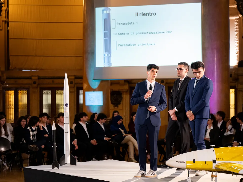 Andrea Beverini and the rocket team explain on stage how the rocket comes back to the ground with the parachutes